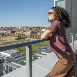 a woman looking over a balcony