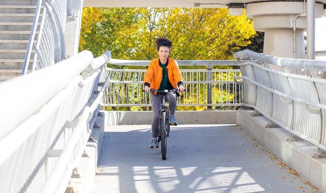 a person riding a bicycle on a bridge