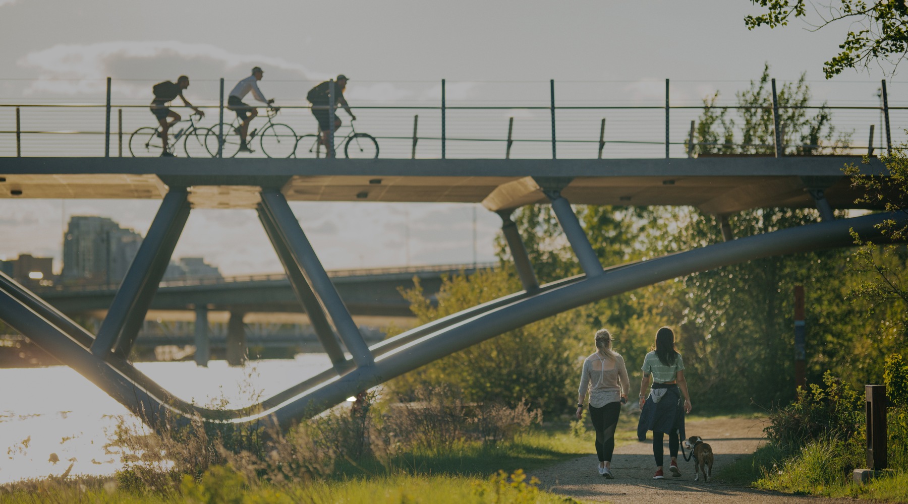 people running and riding on a bridge