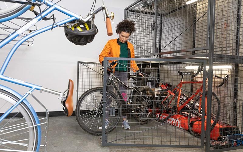 a boy standing next to a bike rack